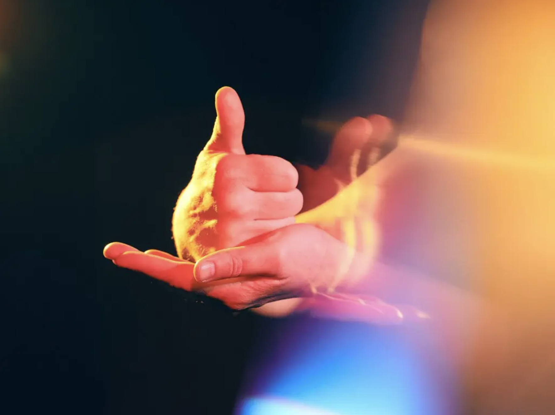 The sign for 'help': one fist with a thumb up rests on the other hand, which is flat.